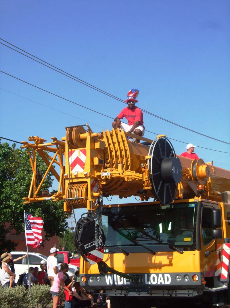 photo of men on top of large equipment in the July 4th, 2012 Parade